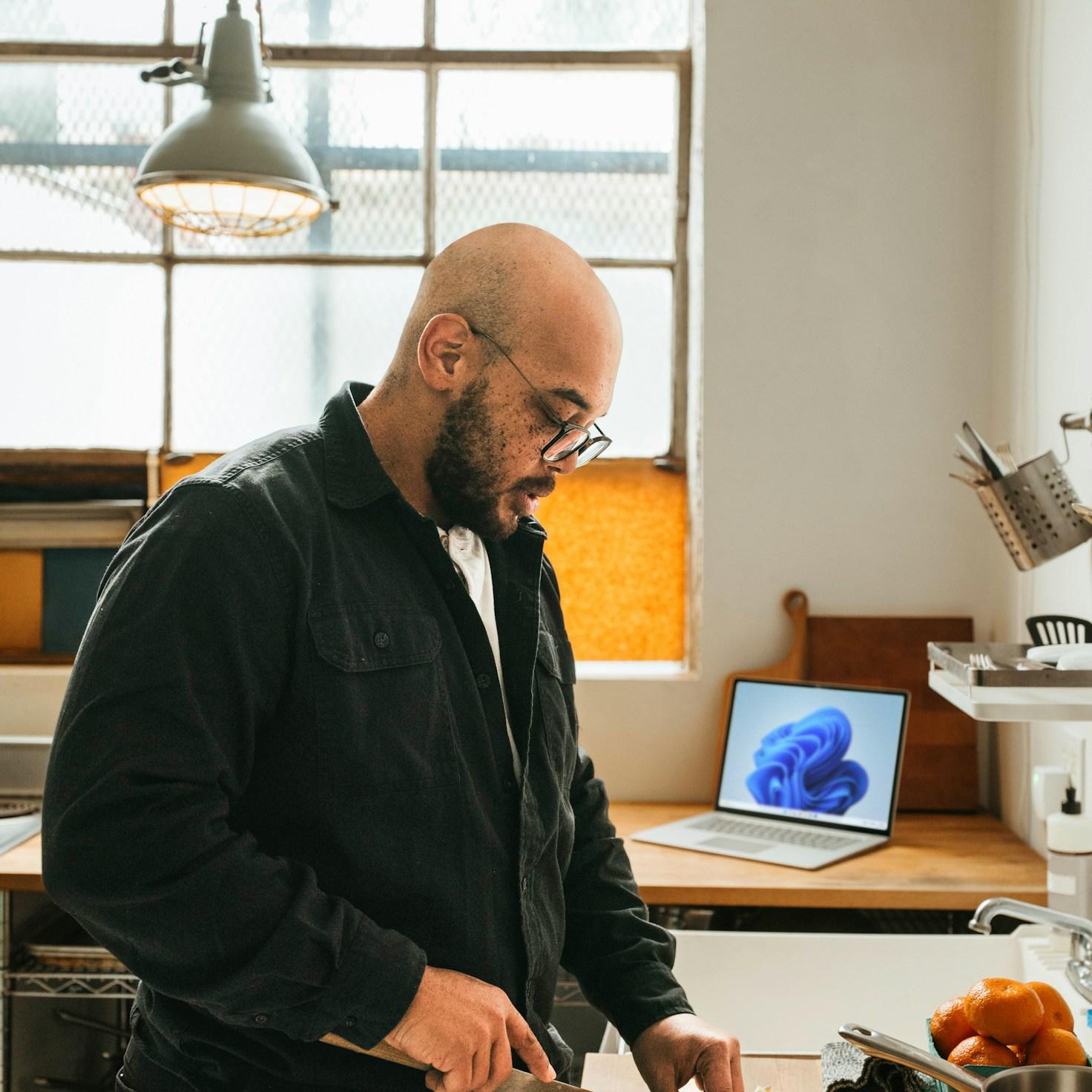 Diverse group of community members sharing a meal together, showcasing the social bonds formed through collaborative cooking